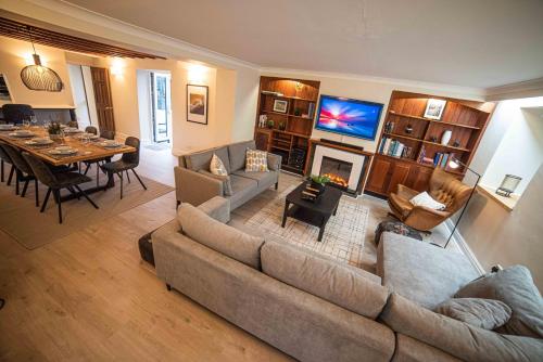 a living room with a couch and a dining room at Timber Hill - Parkfields in Haverfordwest