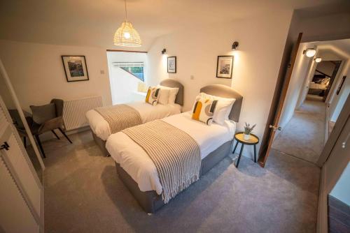 a bedroom with two beds and a mirror at Timber Hill - Parkfields in Haverfordwest