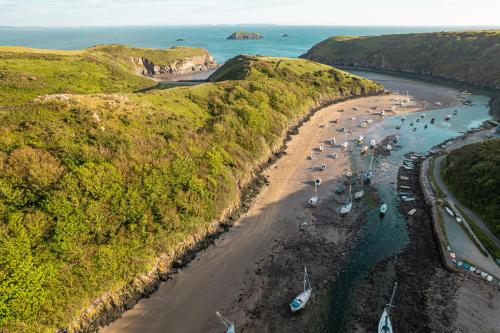 an aerial view of a beach with boats in the water at Timber Hill - Parkfields in Haverfordwest