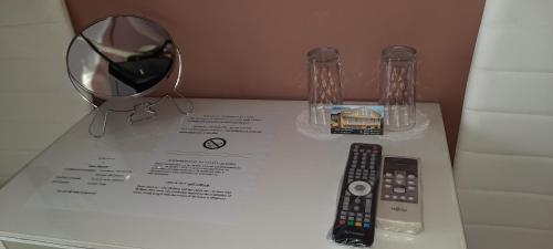 a table with two remote controls and a mirror at MARIANA - guest rooms in Gotse Delchev