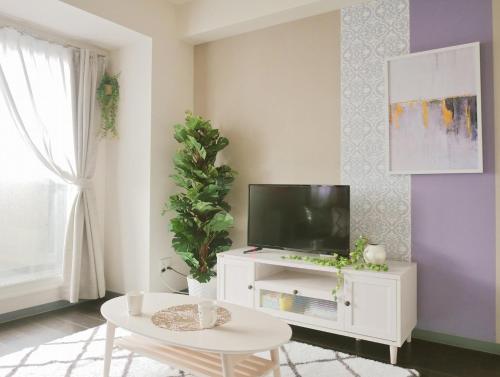 a living room with a tv on a white cabinet at Suncourt Hondori Garden Hills / Vacation STAY 7584 in Sapporo