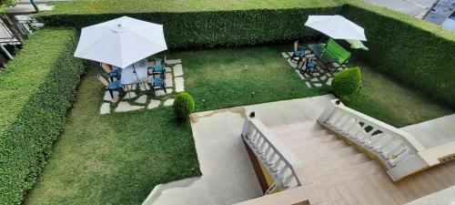 an overhead view of a garden with chairs and an umbrella at MARIANA - guest rooms in Gotse Delchev