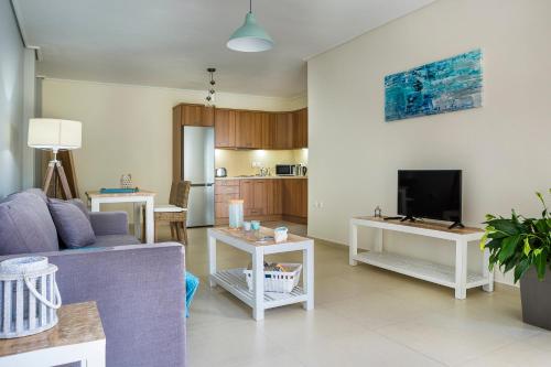 a living room with a couch and a tv at Apartment Lilly, apartment with communal pool, 10 meters from sea in Sami