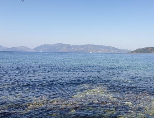 a large body of water with mountains in the background at Apartment Lilly, apartment with communal pool, 10 meters from sea in Sami