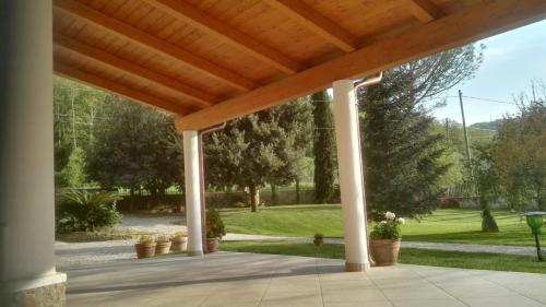 a porch with a wooden roof with potted plants at Villa Lucilla in Altavilla Silentina