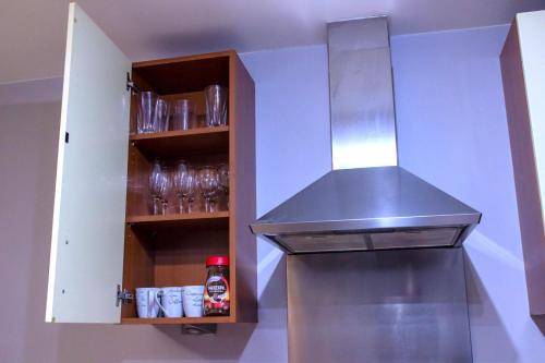 a kitchen with a stainless steel stove top oven at Allen Luxury Apartment in Coventry