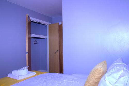 a bedroom with a bed and a blue wall at Allen Luxury Apartment in Coventry
