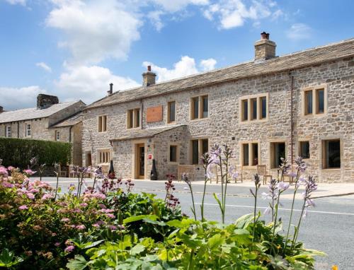 a stone building with flowers in front of it at Breeze Place in Nelson