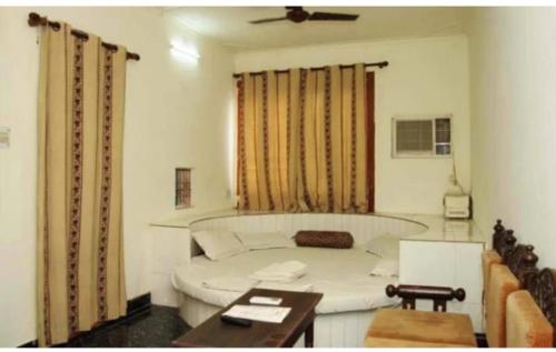 a hotel room with a large bed and a large window at Sai Palace Walking Distance From TajMahal in Agra