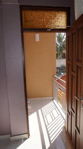 an open door to a balcony with a view of a building at Jakicha Motel in Dar es Salaam