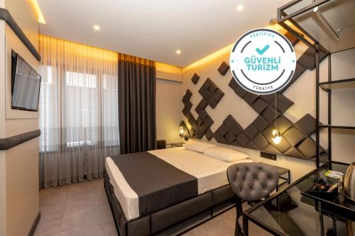 a hotel room with a bed and a chair at White Palace Hotel in Istanbul