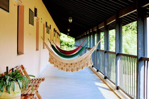 a hammock hanging from the ceiling of a porch at Polo Hotel Fazenda in Indaiatuba