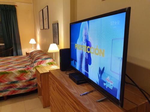 a flat screen tv sitting on a dresser in a bedroom at B3 Apartments in Formosa