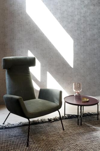a green chair and a table in a room at Palazzo Pianca in Venice