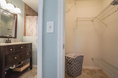 a bathroom with a sink and a mirror at Beach House! in Clearwater Beach