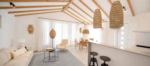 a living room with a couch and a table at Casas da Praia by Sevencollection in Salema