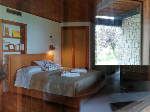 a bedroom with a bed and a large window at Ca' Dei Ste in Valle