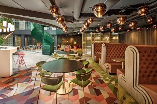 a rendering of a restaurant with tables and chairs at The Florian Amsterdam Schiphol Airport, WorldHotels Crafted in Hoofddorp