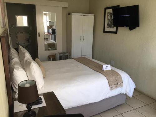 Ένα ή περισσότερα κρεβάτια σε δωμάτιο στο Kayamina Guesthouse