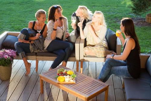 a group of women sitting on a patio at Kuldallika Spa House in Kullamäe