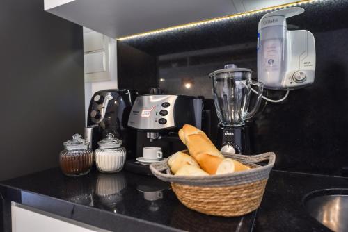a basket of bread on a kitchen counter with a blender at Rosemari's Apartments Republica in Sao Paulo