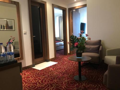 a living room with a couch and a table at Lilac Hotel - Amman in Amman