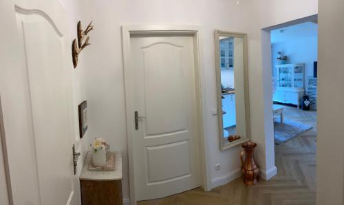 a white door in a hallway with a mirror at Ferienwohnung Rosalie in Inzell