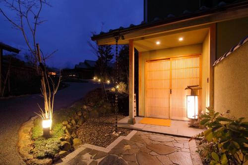 a house with two lights in front of it at night at Bettei Soan in Minami Aso