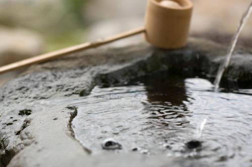 a close up of a table with water on it at Bettei Soan in Minami Aso