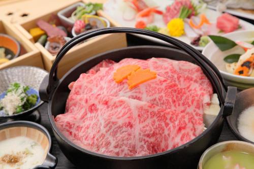 a pan filled with food in a bunch of dishes at Bettei Soan in Minami Aso