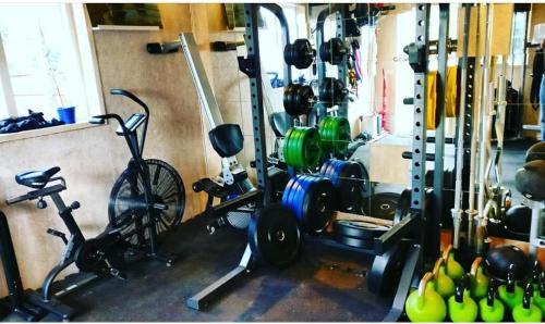 a room with a gym with bikes and weights at Lilla lägenheten Västra Karstorp in Aneby