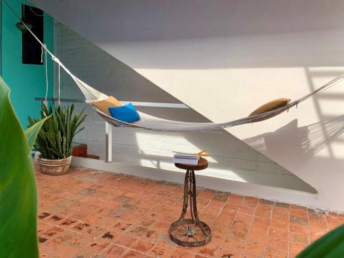 a hammock in a room with a chair and a table at Unique Studio Beach RG4 in Puerto Vallarta