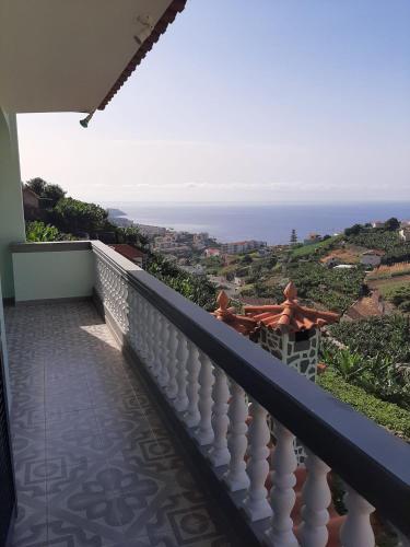 a balcony with a view of the ocean at Casa do Terço in Câmara de Lobos