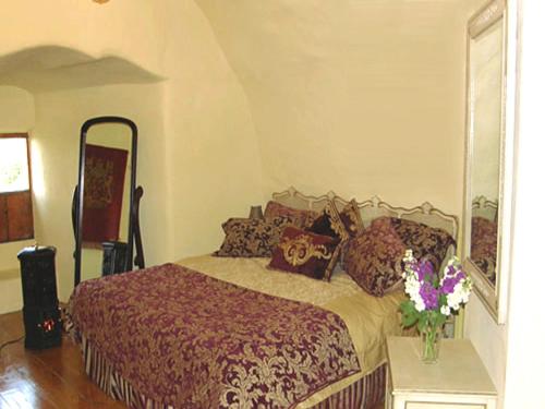 a bedroom with a bed and a vase of flowers on a table at Faside Estate in Musselburgh