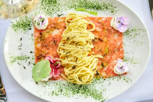 a plate of pasta on a white plate at Lebeaubylivingroom Hotel in Knokke-Heist