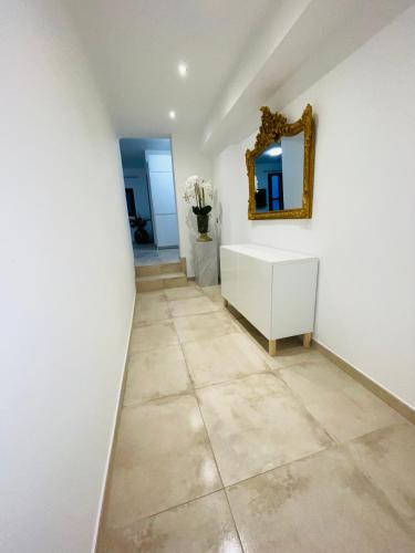 a hallway with a vanity and a mirror on a wall at Magnifique Villa « Le Rocher de Noha »Côte d’Azur in Vence