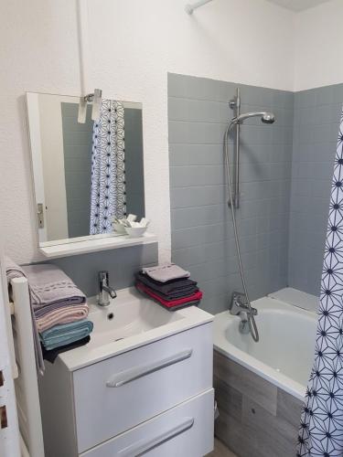 a bathroom with a sink and a shower and a tub at Duplex F3 hypercentre Cherbourg près du port in Cherbourg en Cotentin