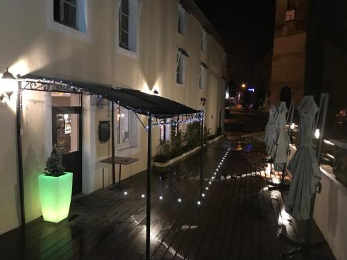a patio at night with a tent and lights at Hôtel D’Artiste in Pierrefontaine-les-Varans