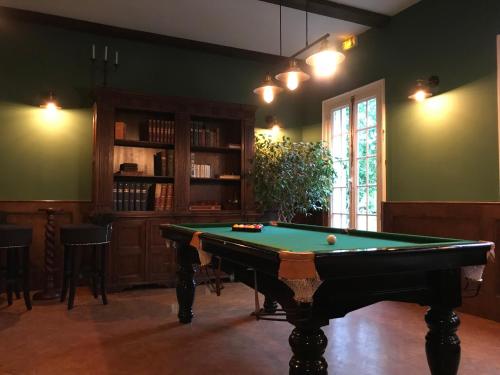 a living room with a pool table in it at Hôtel D’Artiste in Pierrefontaine-les-Varans