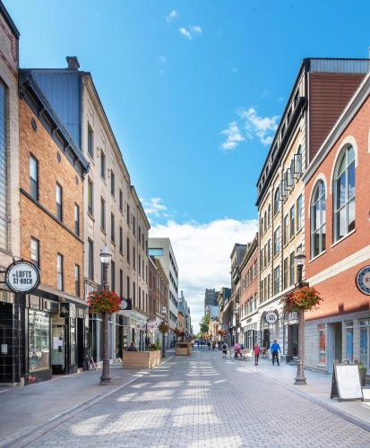 an empty street in a city with buildings at Les Lofts St-Jo - Par Les Lofts Vieux-Québec in Quebec City