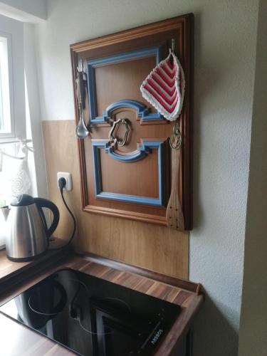 a mirror on a wall above a kitchen sink at Ochsenhof in Feuchtwangen