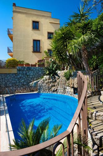 a swimming pool in front of a house at L'Ulivo Resort in Vico Equense