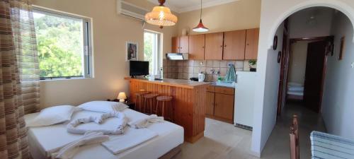 a kitchen with two beds in a room at Anna Studio and Apartments in Tsilivi