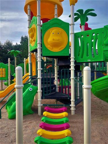 a playground with a slide in a park at Aparton in Ustka