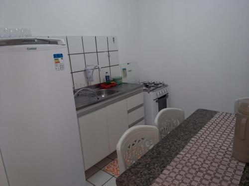 a small kitchen with a sink and a stove at Solaris Sul in Teresina