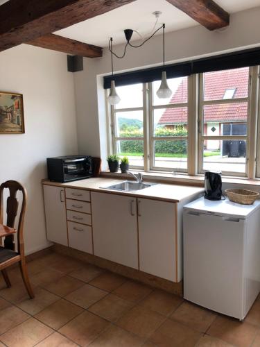 a kitchen with a sink and a window at Storkereden in Tjele