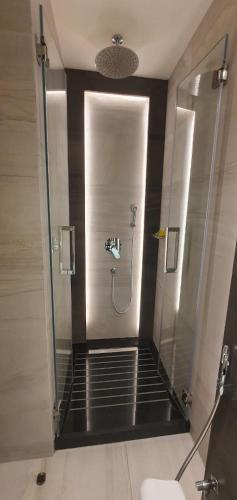 a shower stall in a bathroom with a glass door at Lilac Hotel - Amman in Amman