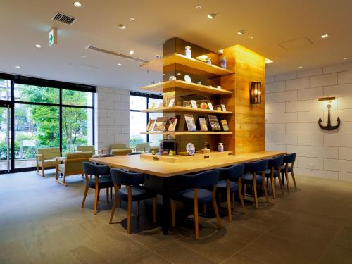 a large dining room with a large wooden table and chairs at Far East Village Hotel Yokohama in Yokohama