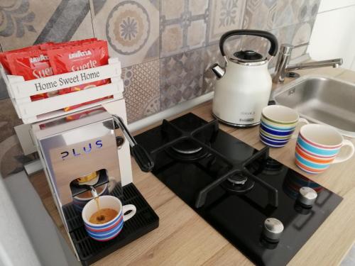 a stove top with a cup of coffee on it at CASAGIO' in Ragusa
