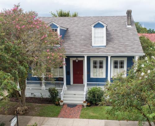 a blue house with a red door at The Beaumont House Natchez in Natchez